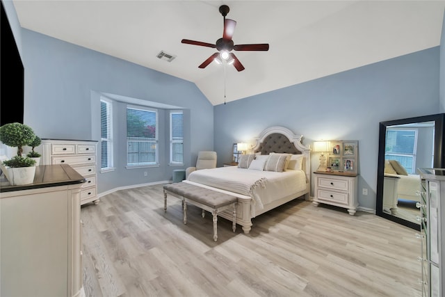 bedroom featuring ceiling fan, light hardwood / wood-style flooring, and lofted ceiling