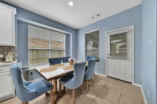 dining room featuring light tile patterned floors and a healthy amount of sunlight