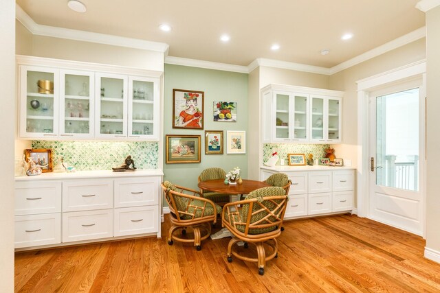 dining room featuring light wood-type flooring and ornamental molding