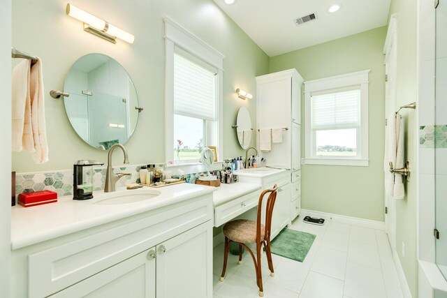 bathroom with walk in shower, vanity, tile patterned floors, and a wealth of natural light