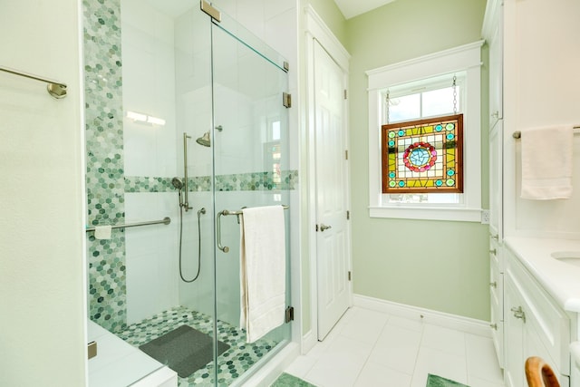 53 Island Psge, Galveston, TX 77554 - bathroom featuring a stall shower, baseboards, vanity, and tile patterned floors