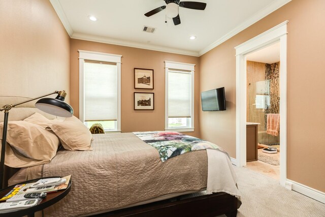 bedroom featuring light carpet, ceiling fan, ensuite bathroom, and crown molding