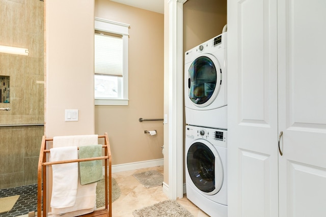 53 Island Psge, Galveston, TX 77554 - laundry area featuring baseboards, stacked washer and clothes dryer, laundry area, and light tile patterned floors