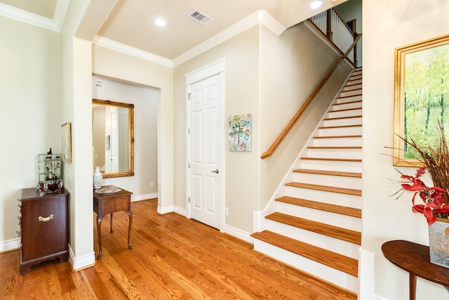 53 Island Psge, Galveston, TX 77554 - stairs with visible vents, crown molding, baseboards, wood finished floors, and recessed lighting