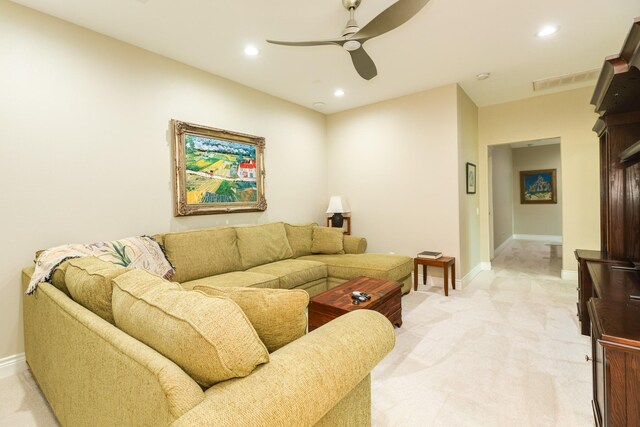 living room featuring light carpet and ceiling fan