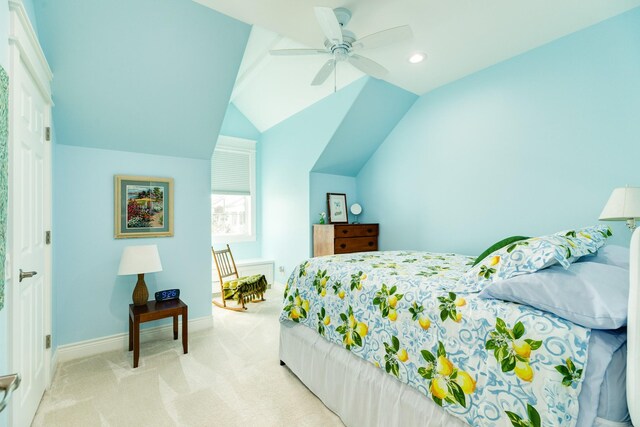 carpeted bedroom with vaulted ceiling and ceiling fan