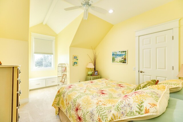 carpeted bedroom with ceiling fan and vaulted ceiling with beams