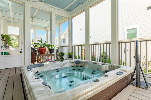 sunroom / solarium with a hot tub and ceiling fan