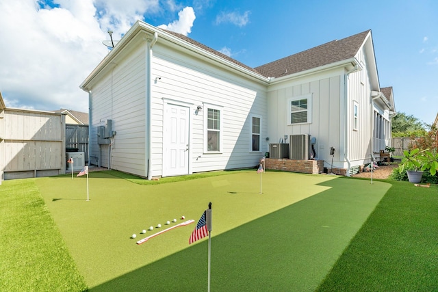 53 Island Psge, Galveston, TX 77554 - rear view of house with a gate, fence, board and batten siding, and central AC