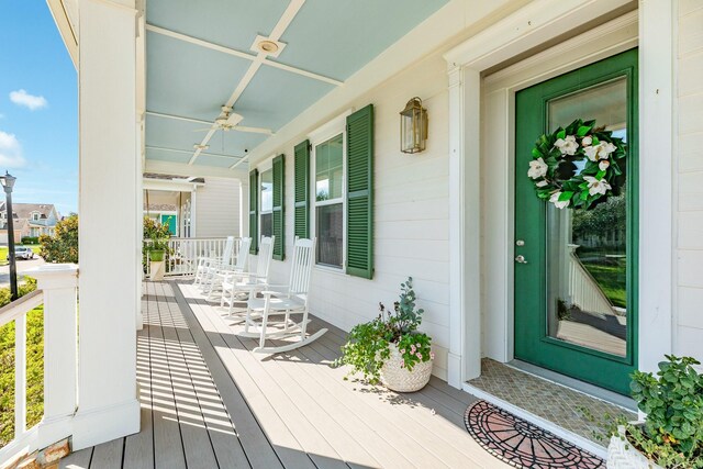 wooden terrace with ceiling fan and a porch