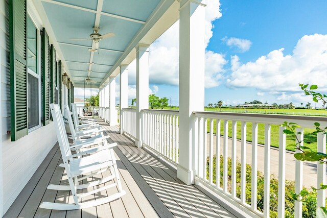 wooden deck featuring ceiling fan and covered porch