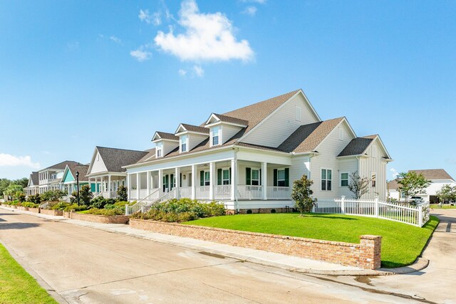 view of front of home with a front yard and a porch