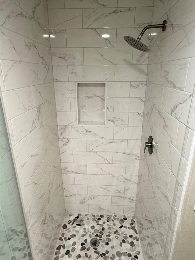 bathroom with a tile shower