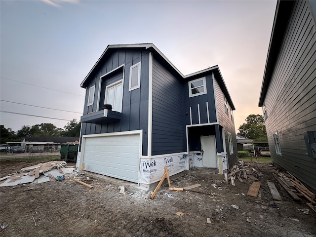 property exterior at dusk featuring a garage