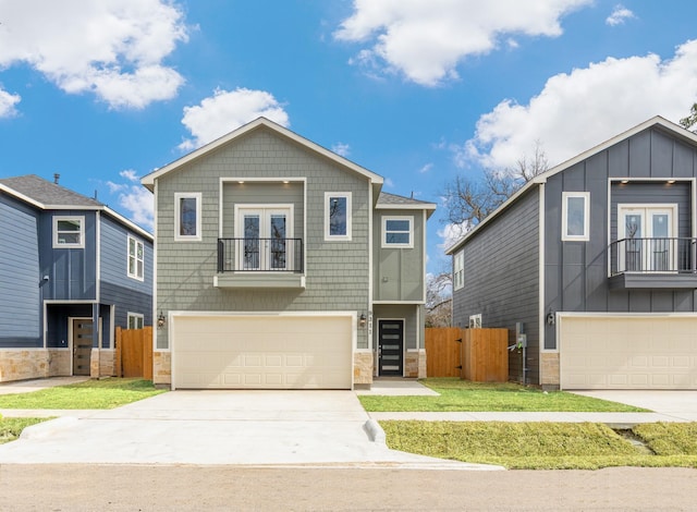 view of front of property with a garage, a balcony, and a front lawn