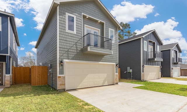 view of front facade featuring a garage, a front lawn, and a balcony