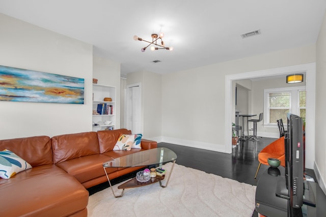 living room with a notable chandelier and wood-type flooring