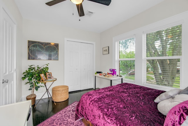 bedroom with hardwood / wood-style floors, ceiling fan, and a closet