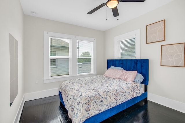 bedroom with ceiling fan and dark wood-type flooring