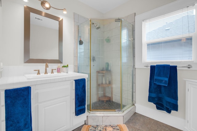 bathroom featuring walk in shower, tile patterned flooring, and vanity