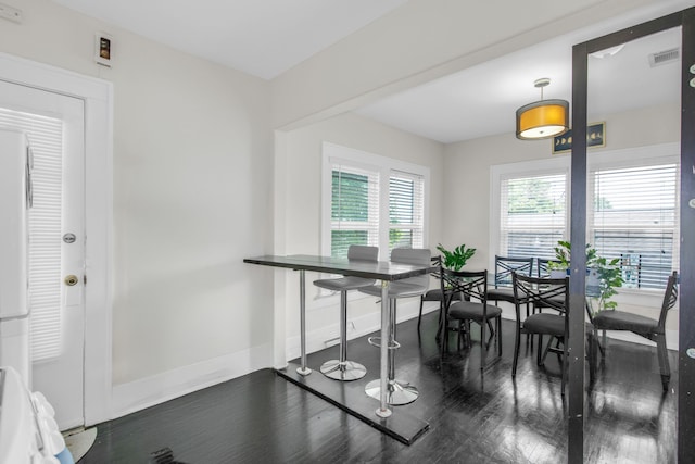 dining area with dark wood-type flooring