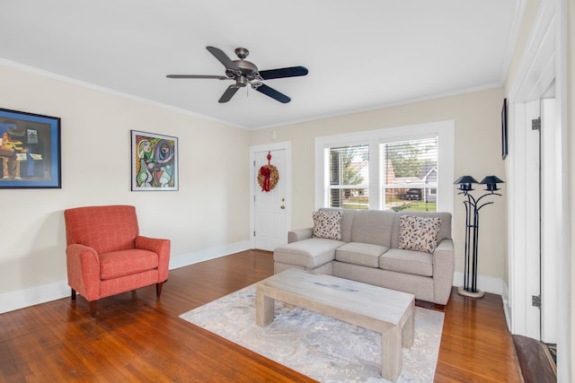 living room with ceiling fan, ornamental molding, and dark hardwood / wood-style flooring