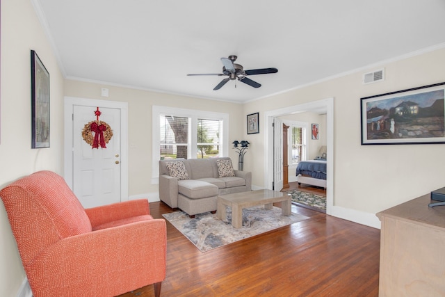 living room with ceiling fan, dark hardwood / wood-style floors, and crown molding