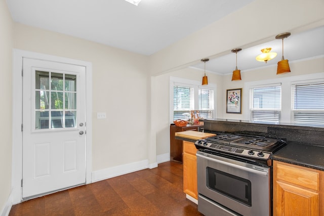 kitchen with stainless steel range with gas cooktop, crown molding, dark hardwood / wood-style flooring, and pendant lighting