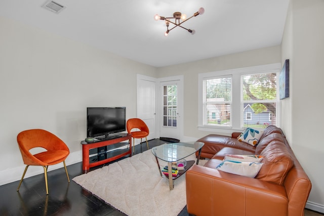 living room featuring a notable chandelier and dark hardwood / wood-style floors