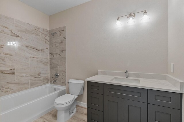 bathroom with hardwood / wood-style flooring, vanity, and toilet