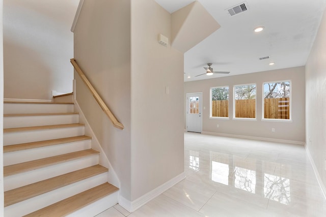 stairway with ceiling fan