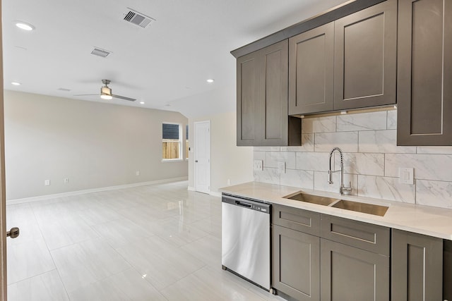 kitchen featuring tasteful backsplash, dishwasher, sink, and ceiling fan