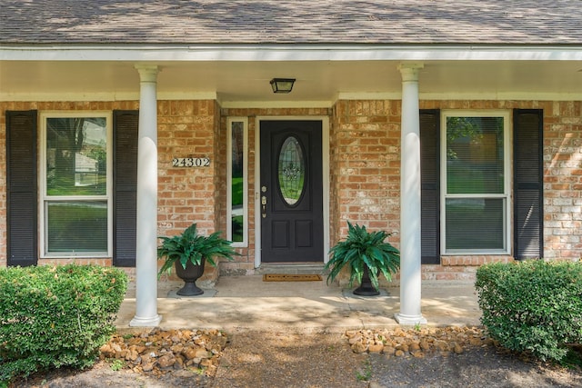 view of exterior entry with covered porch