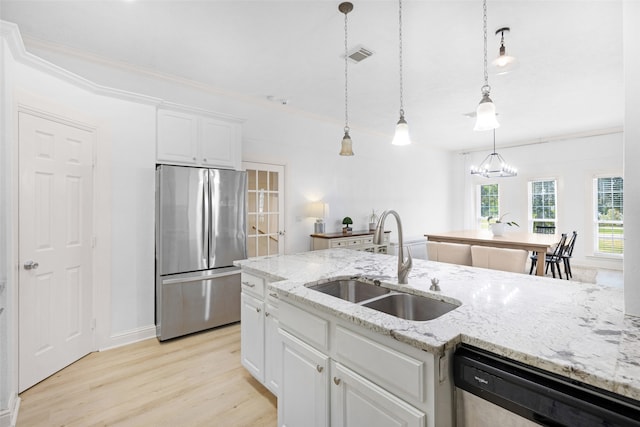 kitchen with sink, hanging light fixtures, light hardwood / wood-style floors, white cabinetry, and stainless steel appliances