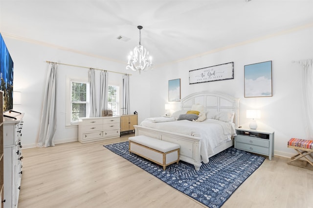 bedroom featuring a chandelier, light wood-type flooring, and crown molding