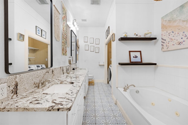 bathroom with tile patterned floors, vanity, toilet, and a tub to relax in