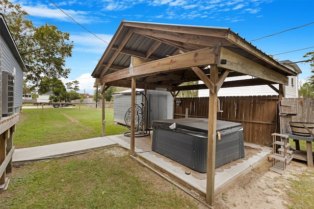 view of yard with a gazebo, a shed, and a hot tub