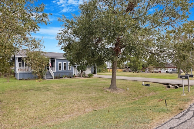 view of front of home featuring covered porch and a front lawn