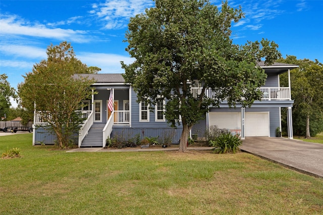 view of front of house featuring a porch, a garage, and a front lawn