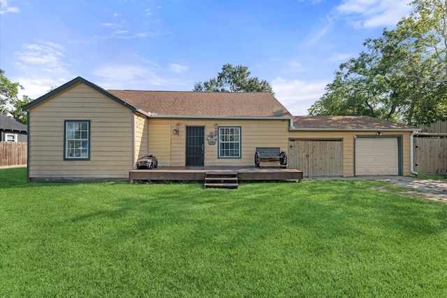 view of front facade with a garage, a deck, and a front lawn