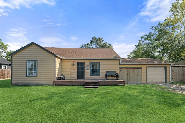 view of front facade with a deck, a garage, and a front yard