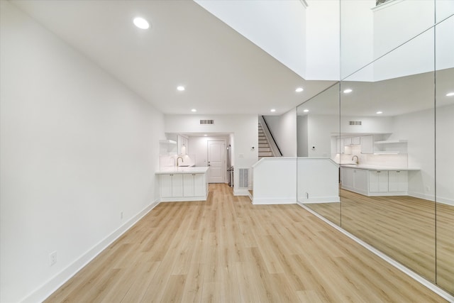 unfurnished bedroom featuring light hardwood / wood-style floors and sink