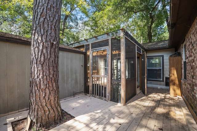 wooden deck featuring a sunroom