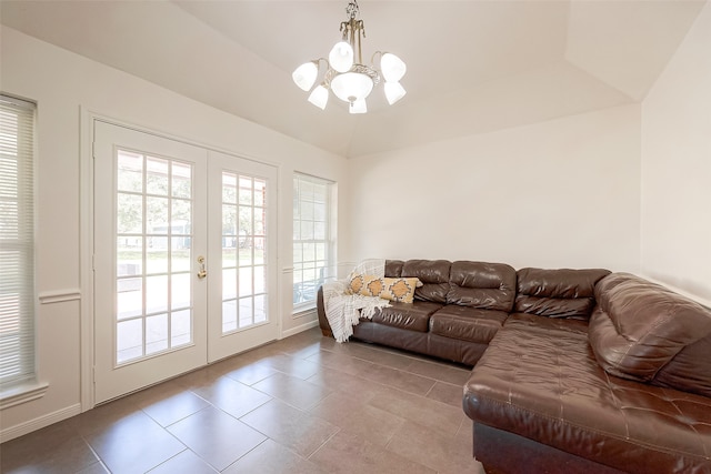 tiled living room featuring vaulted ceiling and a notable chandelier