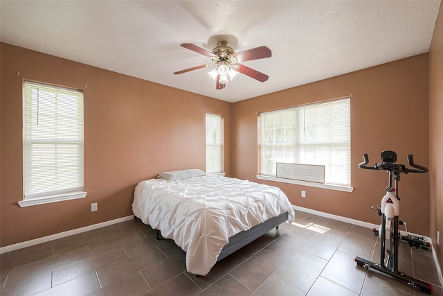 bedroom featuring ceiling fan and dark tile patterned floors