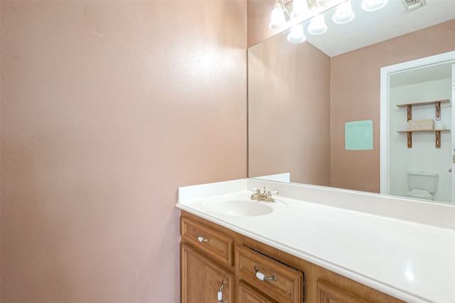 bathroom featuring vanity and toilet