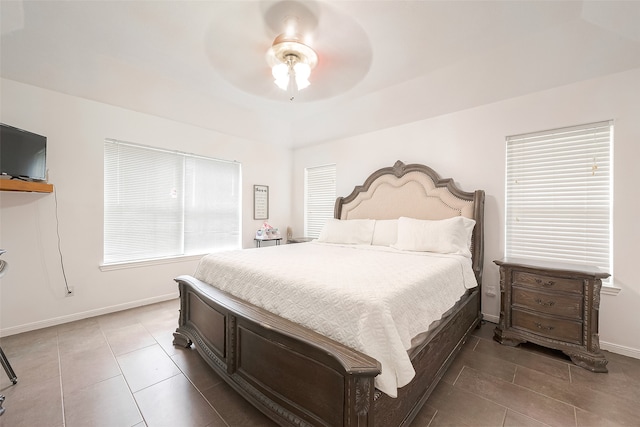 bedroom with ceiling fan and tile patterned floors