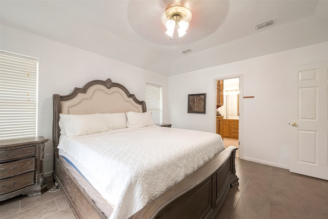 tiled bedroom featuring ceiling fan and ensuite bathroom