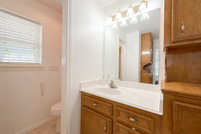 bathroom featuring tile patterned floors, vanity, and toilet