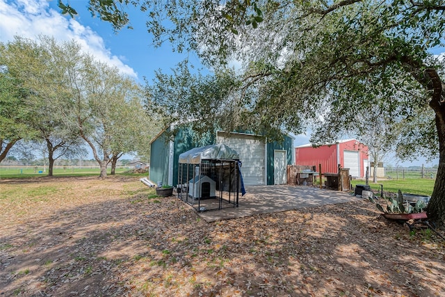 exterior space with a patio and an outbuilding